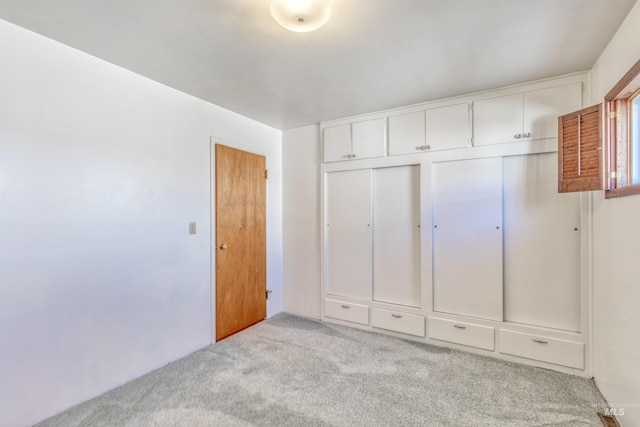 unfurnished bedroom with a closet and carpet flooring