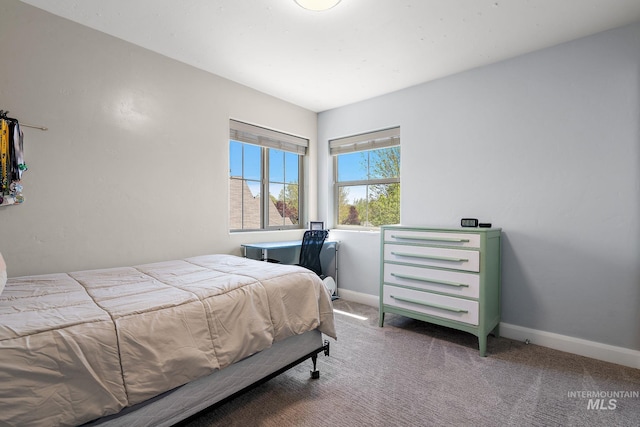 bedroom featuring carpet flooring and baseboards