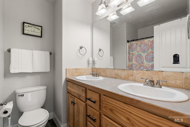 full bathroom with toilet and double vanity