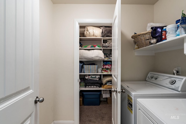 clothes washing area featuring separate washer and dryer and carpet floors