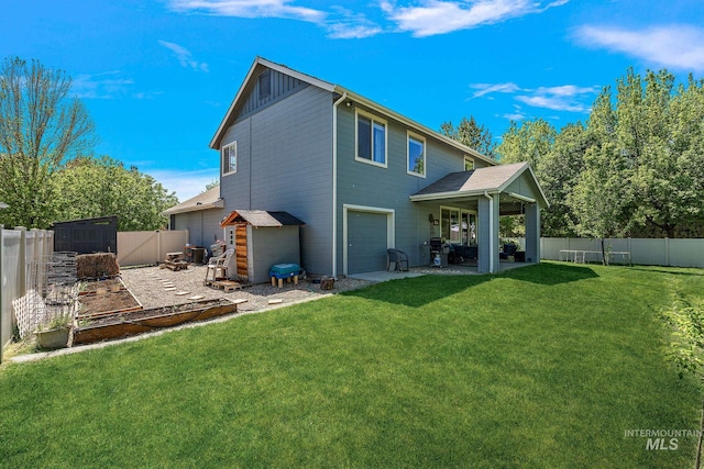 rear view of house with an attached garage and a patio area