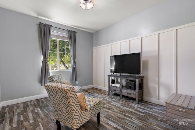 living area featuring dark wood-style flooring and baseboards