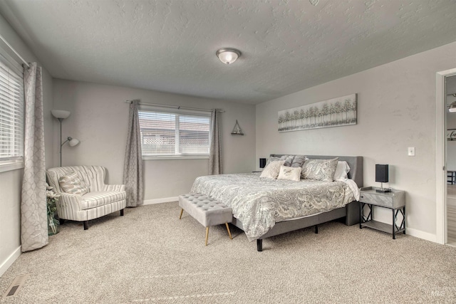 carpeted bedroom with a textured ceiling, baseboards, and visible vents