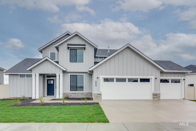 view of front of home featuring a garage and a front lawn