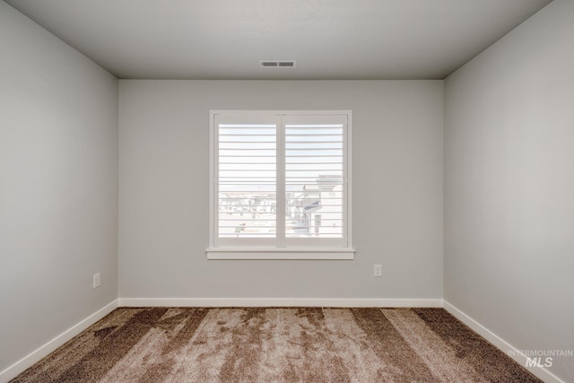 carpeted empty room with baseboards and visible vents