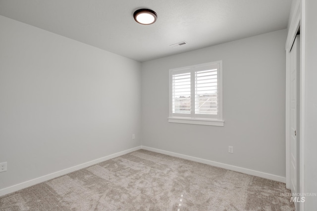 unfurnished bedroom featuring visible vents, baseboards, carpet flooring, and a closet