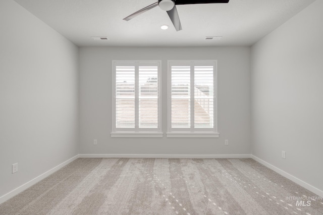 spare room featuring visible vents, a ceiling fan, carpet flooring, and baseboards
