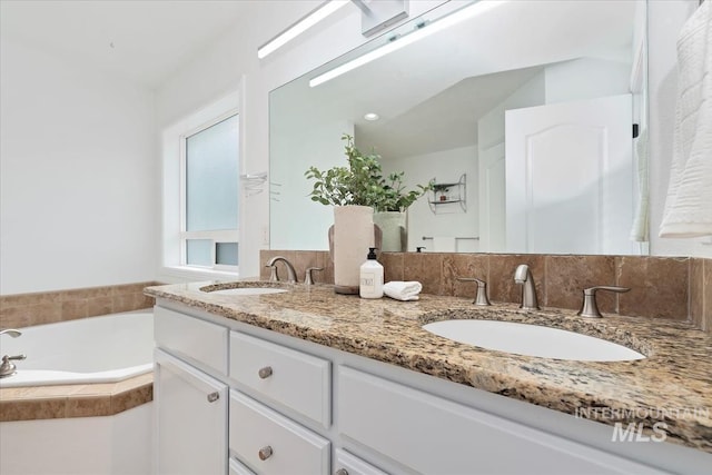 full bath with double vanity, a garden tub, decorative backsplash, and a sink