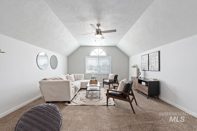 carpeted living area with lofted ceiling, ceiling fan, a textured ceiling, and baseboards