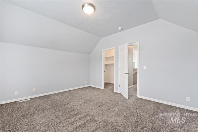 bonus room with lofted ceiling, carpet floors, visible vents, and baseboards