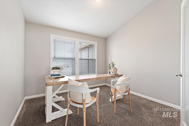 office space featuring baseboards, vaulted ceiling, and carpet flooring