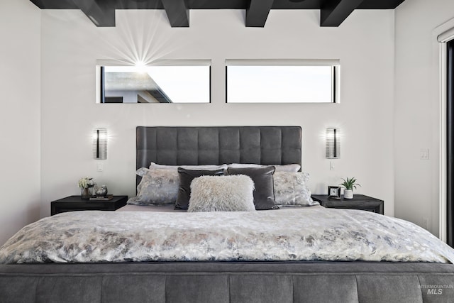 bedroom with beam ceiling