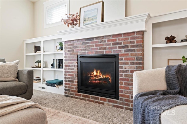 living room featuring carpet floors and a fireplace