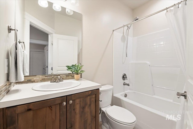 bathroom featuring shower / bath combination with curtain, backsplash, toilet, and vanity