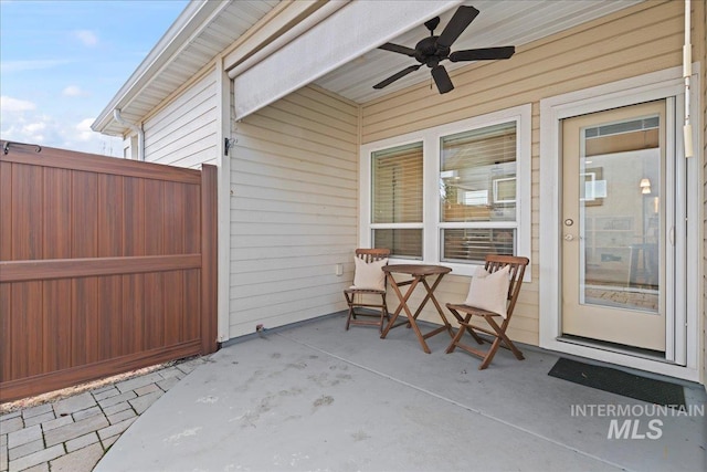 view of patio with ceiling fan and fence