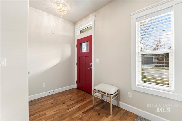 foyer entrance featuring wood finished floors and baseboards