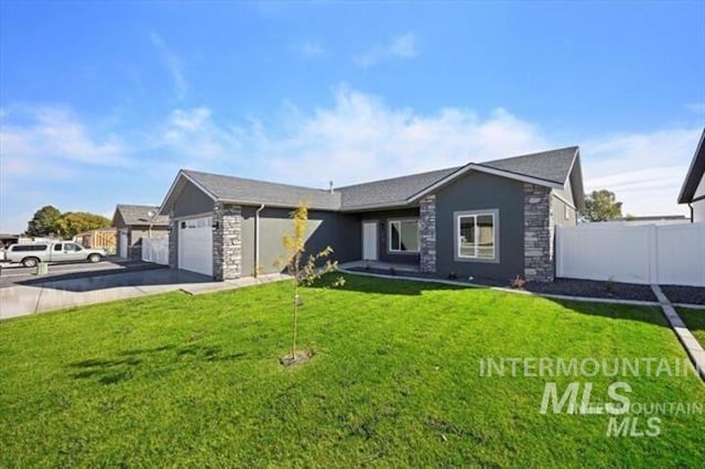 view of front of home featuring a garage and a front lawn