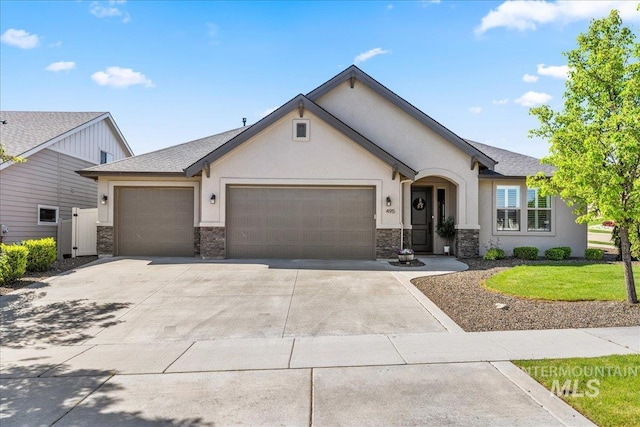 495 W Tall Prairie Dr, Meridian, ID 83642 - view of front of house with an attached garage, stucco siding, stone siding, concrete driveway, and a front yard