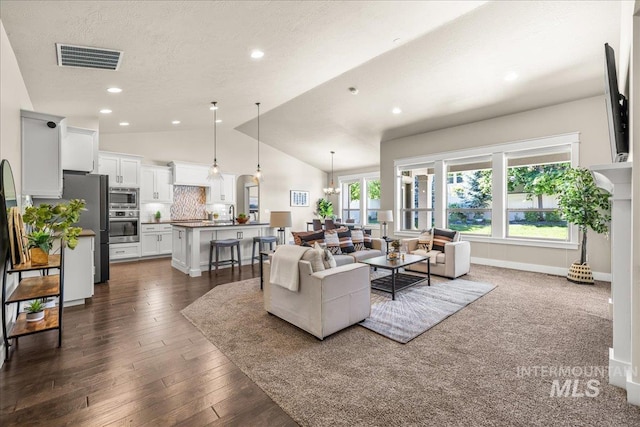 495 W Tall Prairie Dr, Meridian, ID 83642 - living area with lofted ceiling, recessed lighting, dark wood-type flooring, a textured ceiling, and a chandelier