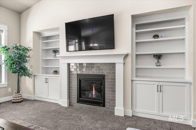 495 W Tall Prairie Dr, Meridian, ID 83642 - unfurnished living room with carpet flooring, built in features, and baseboards
