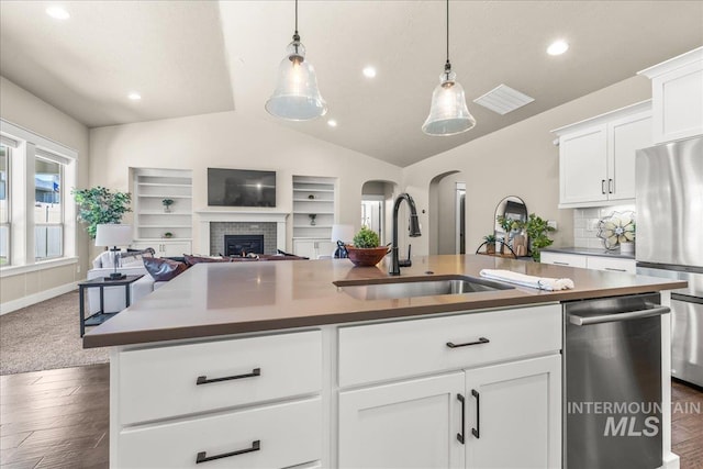 495 W Tall Prairie Dr, Meridian, ID 83642 - kitchen with a sink, open floor plan, appliances with stainless steel finishes, lofted ceiling, and a brick fireplace