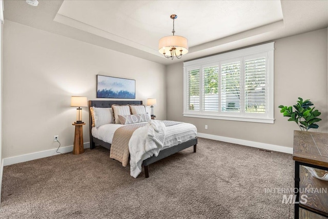 495 W Tall Prairie Dr, Meridian, ID 83642 - carpeted bedroom with a tray ceiling, baseboards, and a chandelier