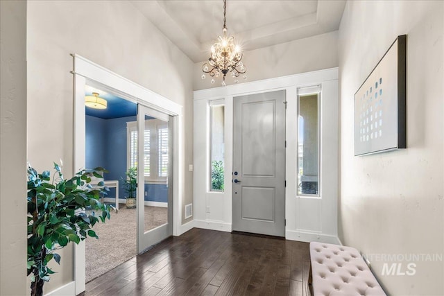 495 W Tall Prairie Dr, Meridian, ID 83642 - entryway with dark wood-style floors, a chandelier, and baseboards