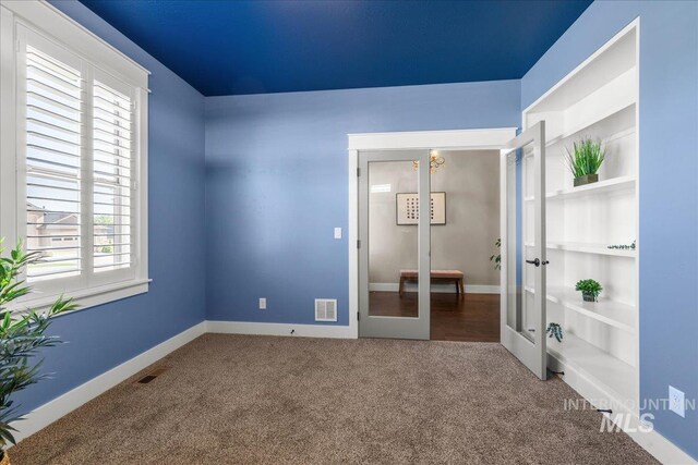 495 W Tall Prairie Dr, Meridian, ID 83642 - unfurnished bedroom with french doors, carpet floors, and baseboards