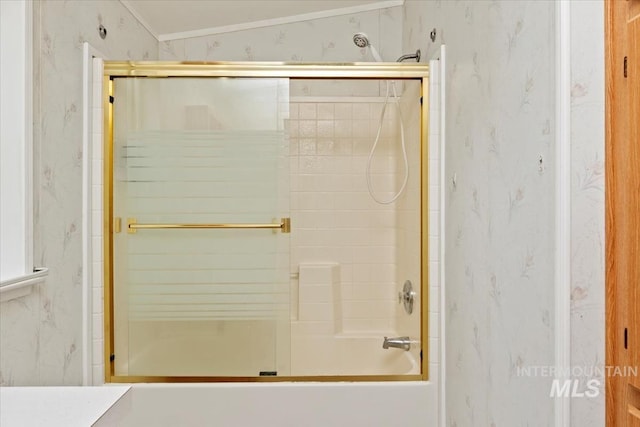 bathroom with wallpapered walls and enclosed tub / shower combo