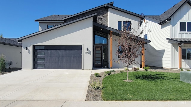 view of front of property with a front yard and a garage