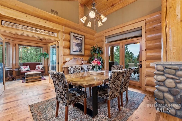 1533 Pine Lakes Ranch Dr, Cascade, ID 83611 - dining room with log walls, light wood-type flooring, high vaulted ceiling, healthy amount of natural light, and french doors
