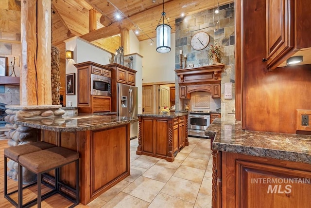 1533 Pine Lakes Ranch Dr, Cascade, ID 83611 - kitchen featuring appliances with stainless steel finishes, high vaulted ceiling, a wood ceiling with exposed beams, brown cabinetry, and a peninsula
