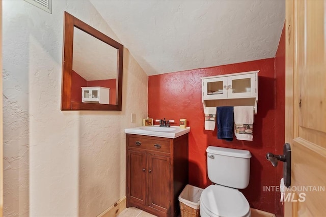 1533 Pine Lakes Ranch Dr, Cascade, ID 83611 - bathroom featuring vanity, a textured wall, and vaulted ceiling