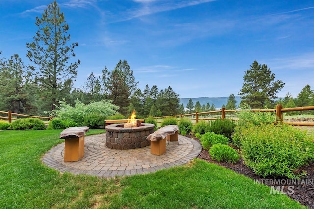 1533 Pine Lakes Ranch Dr, Cascade, ID 83611 - view of yard featuring an outdoor fire pit, a patio area, and a mountain view