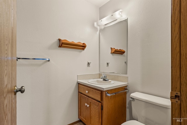 half bath with vanity and toilet