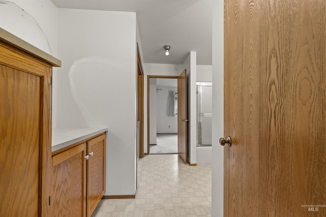 bathroom featuring a shower with shower door and tile patterned floors