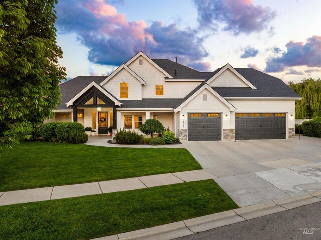 1912 N Bottle Creek Pl, Eagle, ID 83616 - modern farmhouse with concrete driveway, a yard, board and batten siding, a garage, and stone siding