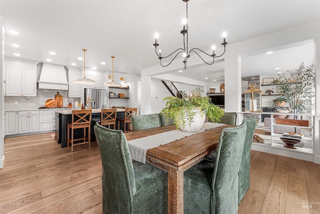 1912 N Bottle Creek Pl, Eagle, ID 83616 - dining space featuring a chandelier, light wood finished floors, and recessed lighting