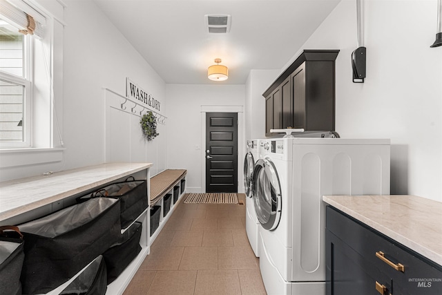 1912 N Bottle Creek Pl, Eagle, ID 83616 - clothes washing area featuring cabinet space, washer and dryer, and healthy amount of natural light