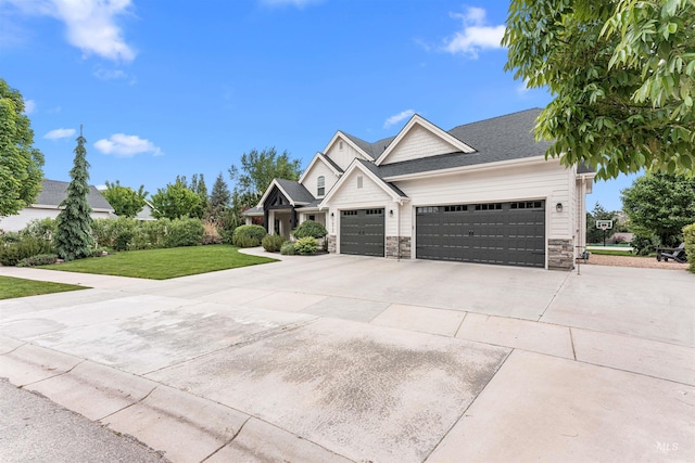 1912 N Bottle Creek Pl, Eagle, ID 83616 - view of front facade with stone siding, an attached garage, concrete driveway, and a front yard