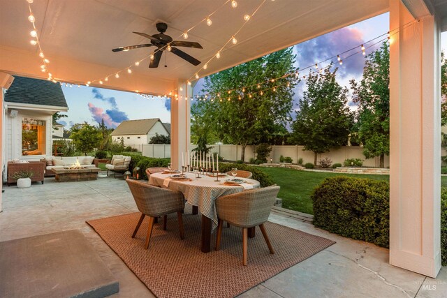 1912 N Bottle Creek Pl, Eagle, ID 83616 - patio terrace at dusk featuring an outdoor living space with a fire pit, outdoor dining area, and ceiling fan