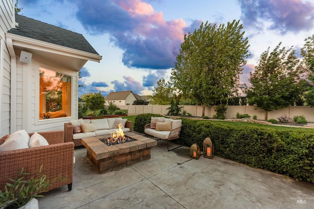 1912 N Bottle Creek Pl, Eagle, ID 83616 - patio terrace at dusk featuring an outdoor living space with a fire pit and a fenced backyard