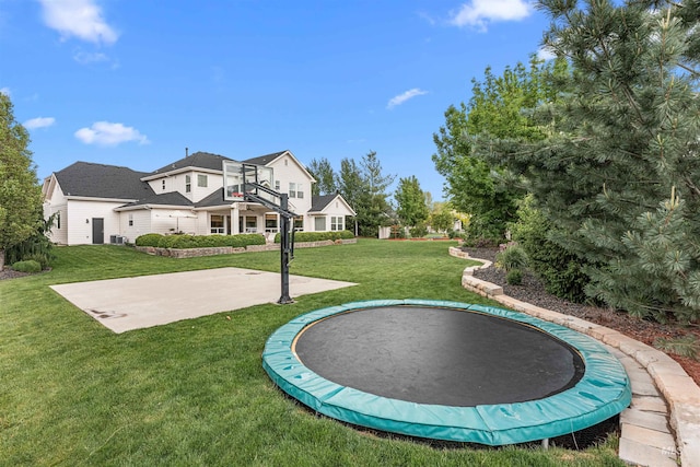 1912 N Bottle Creek Pl, Eagle, ID 83616 - view of basketball court with a trampoline, a lawn, and basketball hoop