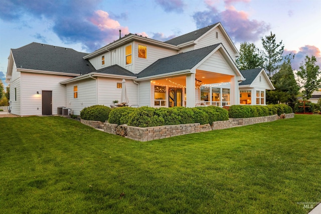 1912 N Bottle Creek Pl, Eagle, ID 83616 - rear view of property with a yard, cooling unit, and board and batten siding