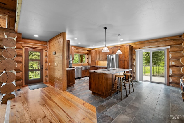 881 Sheila, Mccall, ID 83638 - kitchen featuring appliances with stainless steel finishes, healthy amount of natural light, recessed lighting, a center island, and rustic walls