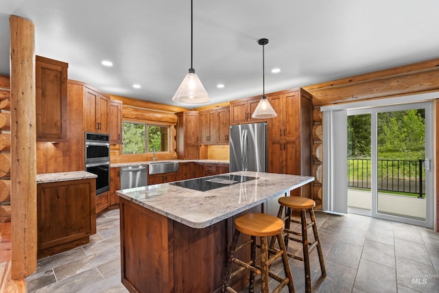 881 Sheila, Mccall, ID 83638 - kitchen featuring appliances with stainless steel finishes, rustic walls, a center island, brown cabinetry, and a kitchen bar