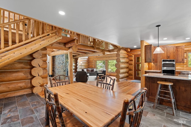 881 Sheila, Mccall, ID 83638 - dining room featuring rustic walls, recessed lighting, and dark stone finish floors