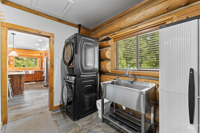 881 Sheila, Mccall, ID 83638 - interior space featuring stacked washer and clothes dryer, log walls, and dark stone finish floors