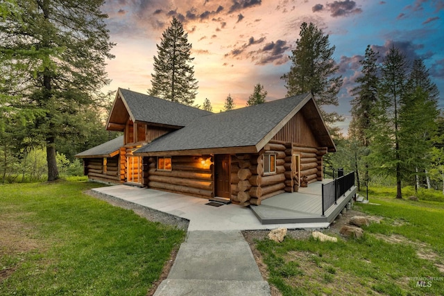 881 Sheila, Mccall, ID 83638 - log home featuring log siding, a lawn, and a shingled roof