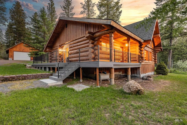 881 Sheila, Mccall, ID 83638 - back of property with log siding, a lawn, stairway, a detached garage, and a shingled roof